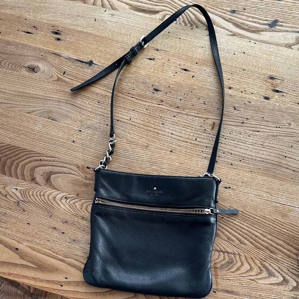 Kate Spade Leather Crossover bag with Black and White Striped Interior.